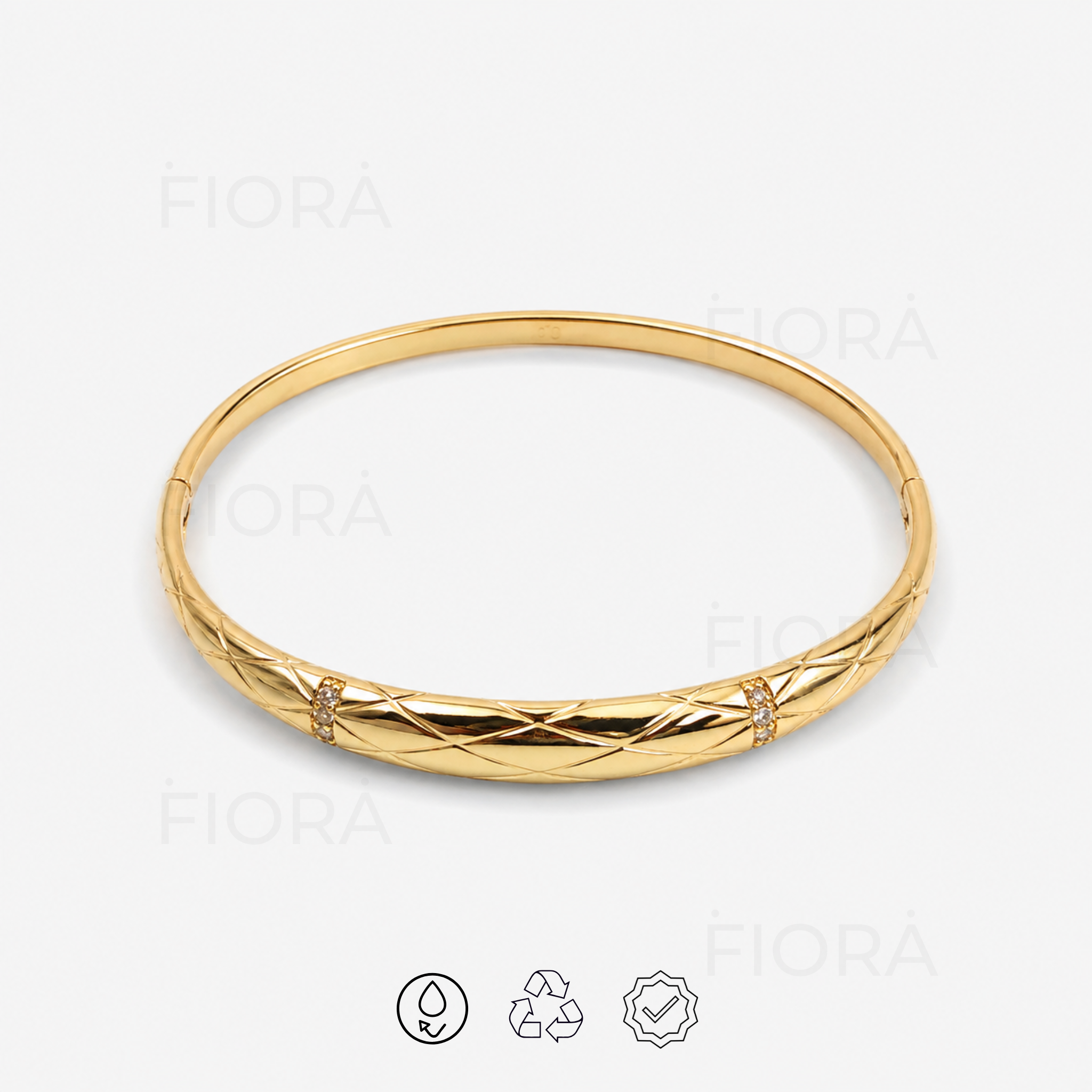 Liora quilted gold bangle with crystal accents front view on a white background.