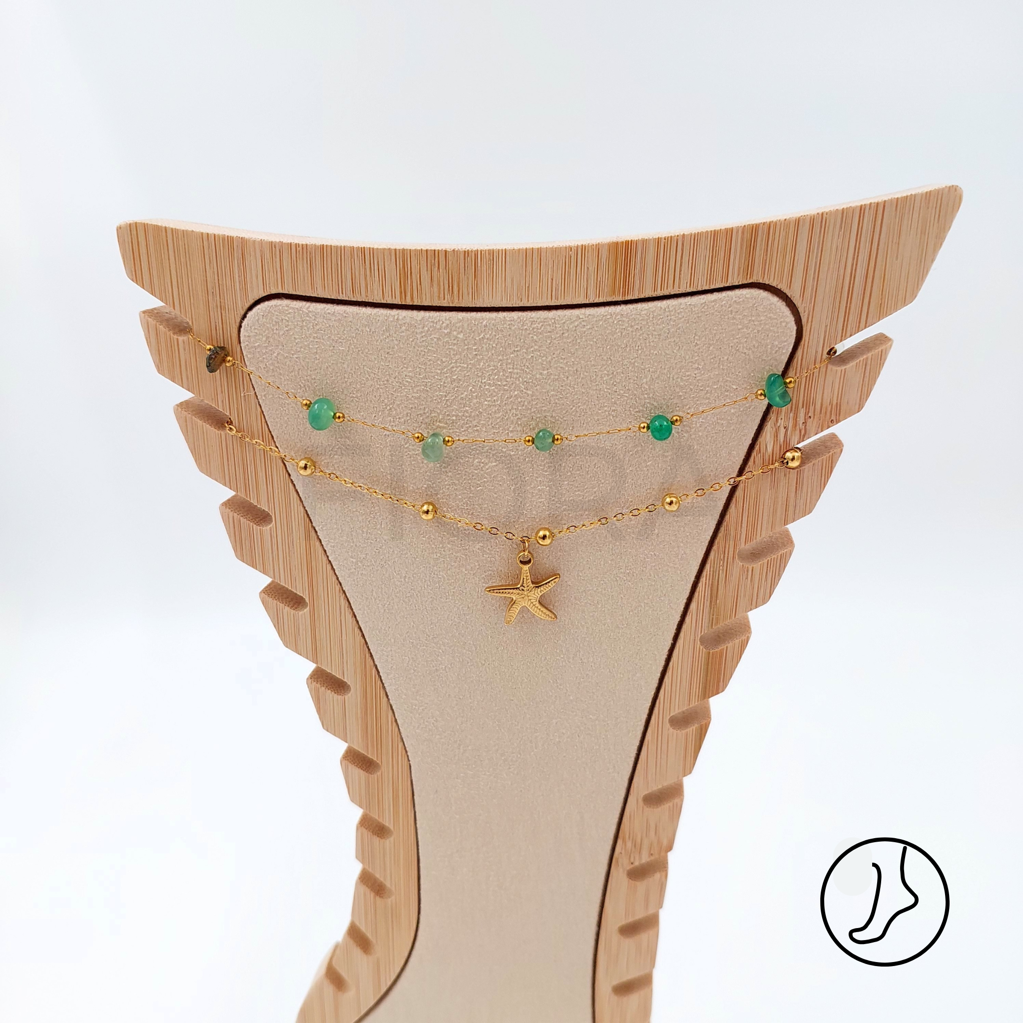 Starfish charm anklet with green beads and gold chain.