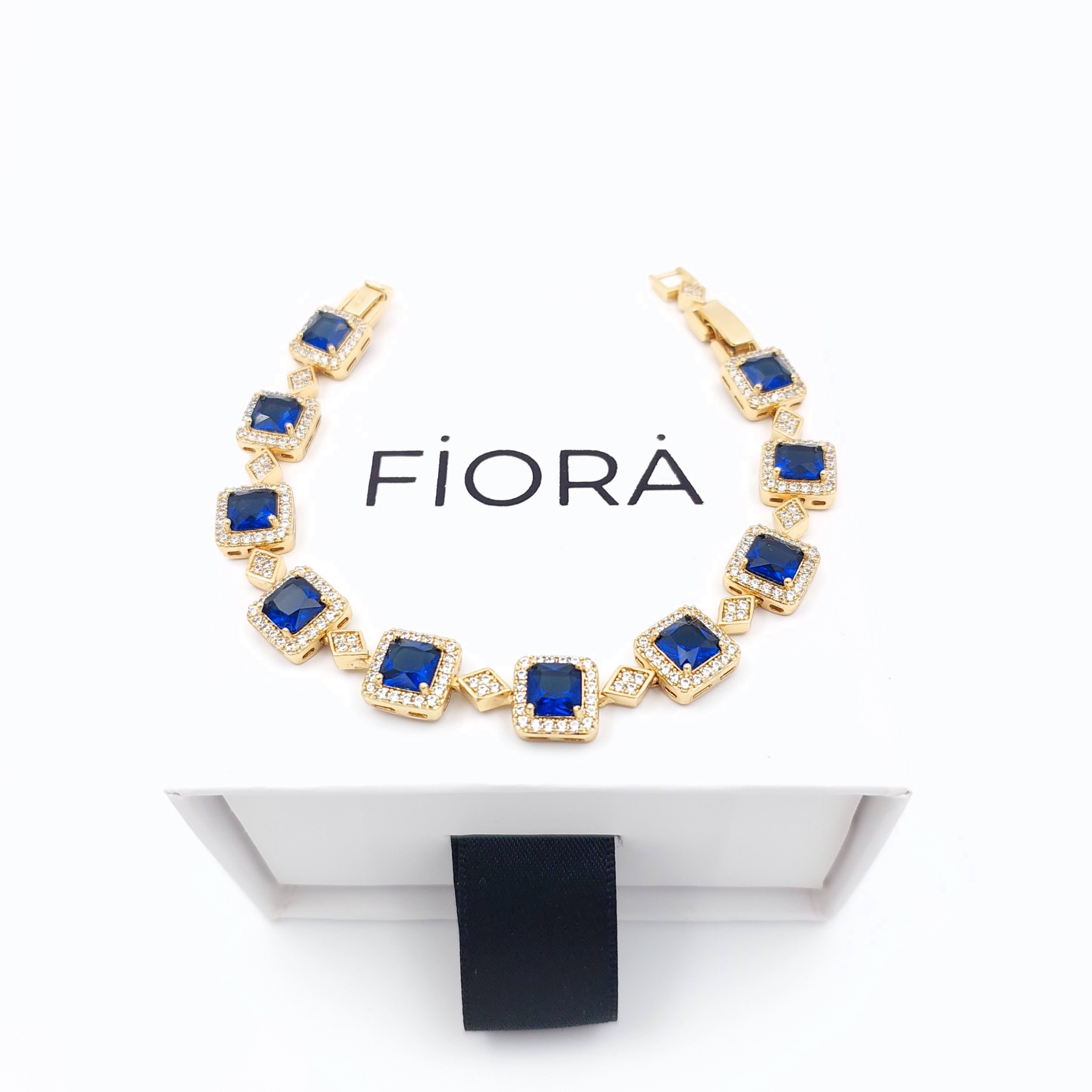 Elegant gold bracelet with square zircon stones and diamond-shaped gold links.